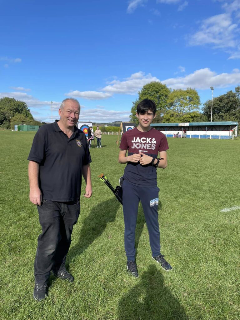 a member being presented with a three gold end badge