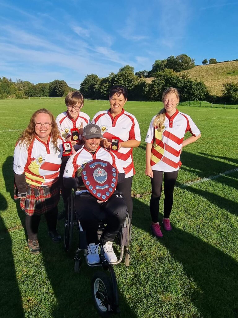 a group of neath archers' holding medals and trophies